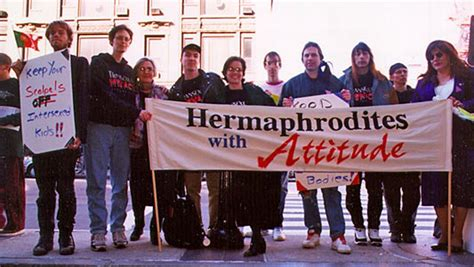 The group standing holding the banner 'Hermaphrodites with Attitude'