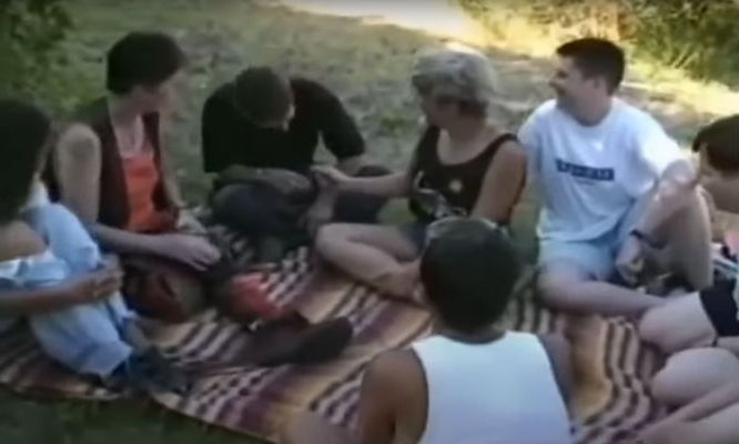 Screenshot from the recording of intersex people sitting on a blanket outdoors in the grass