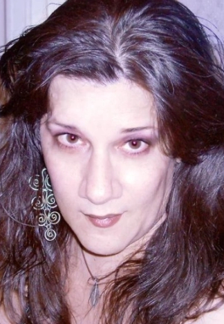 Photo of Maddie with long hair and long decorative earrings